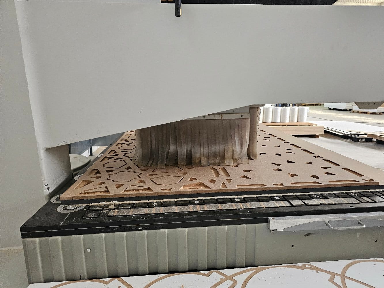 The 5-axis CNC machining an intricate geometric panel at EL Company